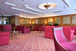 a waiting room with purple chairs and tables at Meliá Caracas in Caracas