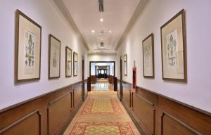 a hallway with a row of paintings on the walls at Meliá Caracas in Caracas