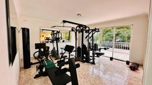 a gym with a lot of treadmills and machines at Hotel Casa Sharon in Cali