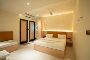 a hotel room with a bed and a window at Freshup Hotel in Tirupati