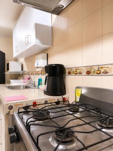 a kitchen with a stove top oven in a kitchen at Apartment Angeluz in San Andrés +10 photos