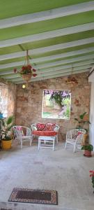 a patio with chairs and a table and a window at Oasi di san Benedetto in Castellaneta