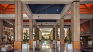 a lobby of a building with columns and tables at Meliá Puerto Vallarta in Puerto Vallarta