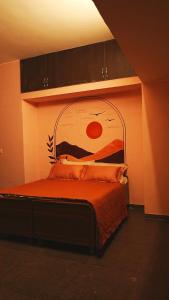 a bedroom with a bed with a painting on the wall at The Saanj Villa in Sānand