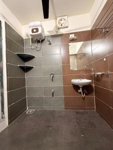 a bathroom with a sink and a mirror at The Saanj Villa in Sānand