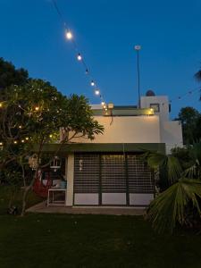 a house with lights on top of it at night at The Saanj Villa in Sānand