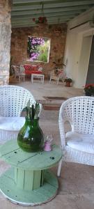 a table with a green vase on top of it at Oasi di san Benedetto in Castellaneta
