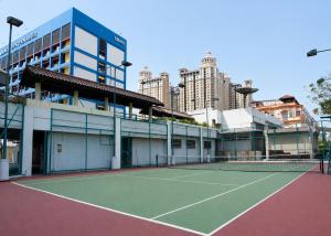 a tennis court in front of a building at Grand Tropic Suites Hotel in Jakarta