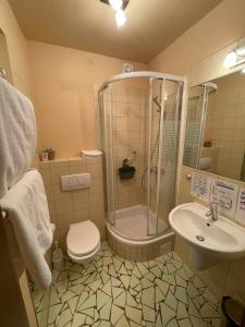 a bathroom with a shower and a toilet and a sink at Motel Pieprzyk in Kołobrzeg
