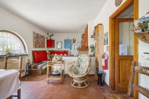 a living room with a table and a chair at La Pennica bnb in Pontremoli +28 photos
