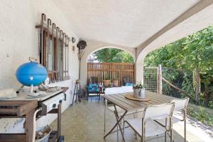 a porch with a wooden table and chairs at La Pennica bnb in Pontremoli