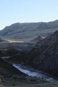 a view of a mountain valley with a river at Central Otago Hydeaway in Hyde +5 photos