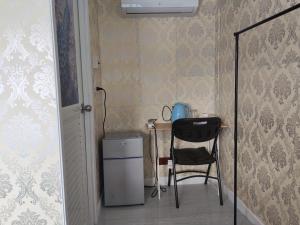 a room with a table and a chair and a desk at Breeze Homestay in Nong Khai
