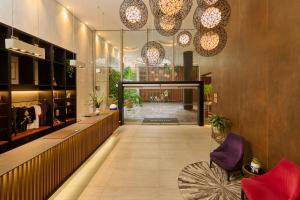 a lobby of a building with purple chairs and lights at INNSiDE by Meliá Lima Miraflores in Lima