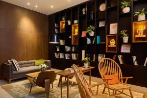 a living room with a couch and a table and chairs at INNSiDE by Meliá Lima Miraflores in Lima