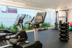 a gym with two tread machines and a large window at INNSiDE by Meliá Lima Miraflores in Lima