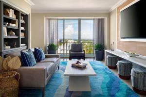 a living room with a couch and a tv at The Ritz-Carlton Key Biscayne, Miami in Miami