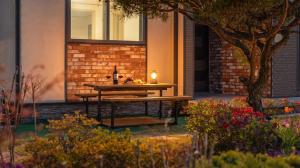 a table in front of a building with a candle on it at Daebudo Freesia Private Pool Villa in Ansan +3 photos