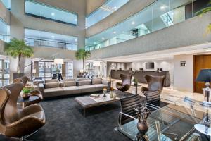 a large living room with a couch and chairs at Meliá Brasil 21 in Brasília