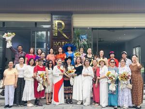 a group of women posing for a picture in front of a building at KHÁCH SẠN R Hotel in Sầm Sơn +23 photos