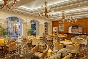 a restaurant with tables and chairs and a chandelier at ITC Grand Central, a Luxury Collection Hotel, Mumbai in Mumbai