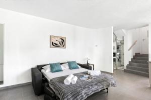 a bedroom with a large bed with blue pillows at Charm Apartments Aldesago in Aldesago