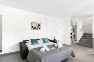 a bedroom with a large bed with blue pillows at Charm Apartments Aldesago in Aldesago