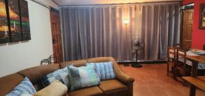 a living room with a couch and a table at Comfortable fully equipped apartment just 6 kilometers from Manuel Antonio, with parking and fast WiFi in Quepos