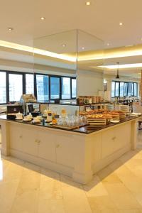 a kitchen with a counter with food on it at Meliá Lima in Lima