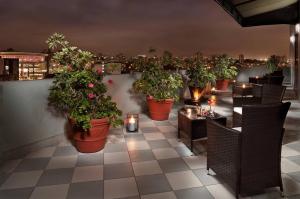 a restaurant with a bunch of potted plants on the wall at Meliá Lima in Lima +67 photos