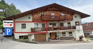 a large house with a balcony on top of it at Ferienwohnung Stern, Natters in Innsbruck