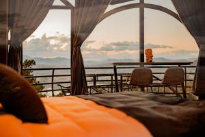 a bedroom with a bed and a table with a view at Valahara Eco-Luxury Camp in Antsirabe +8 photos
