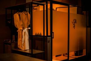 a room with a glass partition with a dress on a shelf at Valahara Eco-Luxury Camp in Antsirabe