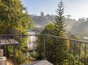 a balcony with a view of a tree at Top Mountain Resort in Diyatalawa