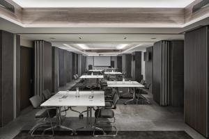 a row of tables and chairs in a room at Hyatt Centric Milan Centrale in Milan +154 photos