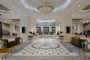a lobby with couches and tables and a chandelier at JW Marriott Bucharest Grand Hotel in Bucharest +180 photos