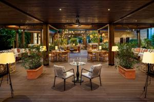 a patio with tables and chairs and a table and chairsktop at JW Marriott Bucharest Grand Hotel in Bucharest