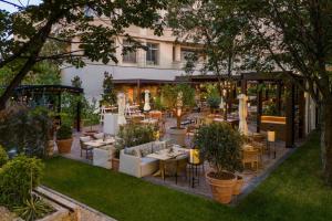 a restaurant with tables and chairs in a garden at JW Marriott Bucharest Grand Hotel in Bucharest