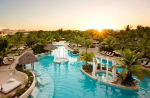 an aerial view of a resort pool with palm trees at Meliá Caribe Beach Resort - All Inclusive in Punta Cana