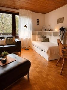 a large bedroom with a bed and a couch at Odw homes - Wohnung im Landhaus mit Garten in Trösel