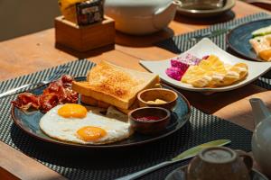 a plate of breakfast foods on a table at The Kaci Penida By Bali Cabin in Nusa Penida