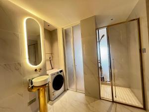 a bathroom with a sink and a washing machine at Vue Aston in Phnom Penh +24 photos