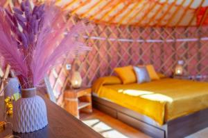 a room with a bed and a vase on a table at Podere Sorrentino in Offida +12 photos