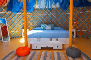 a bedroom with a bed and a sink in a tent at Podere Sorrentino in Offida