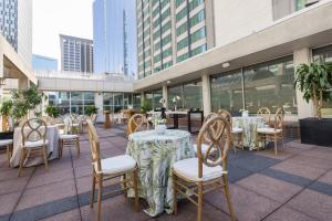 a patio with tables and chairs and tables and buildings at Sheraton Boston Hotel in Boston