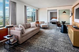 a living room with a couch and a bedroom at Sheraton Boston Hotel in Boston