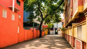 an alley with an orange fence and a tree on the side at Blessings select DLF in Chennai