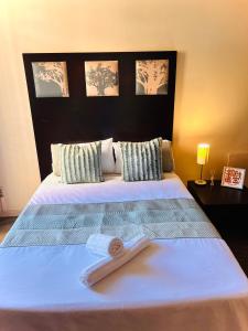 a bedroom with a bed with a book on it at iNtsika Boutique in Johannesburg