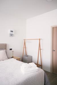 a bedroom with a bed with white sheets at Prouds House in Ban Hua Phlong