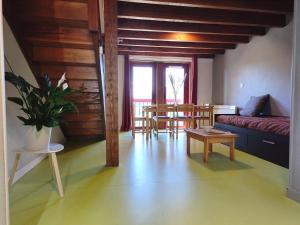 a living room with a couch and a table at Gite la Borie de Pourtou Santoire in Condat